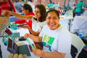Rosa at the market information table helps shoppers using SNAP benefits